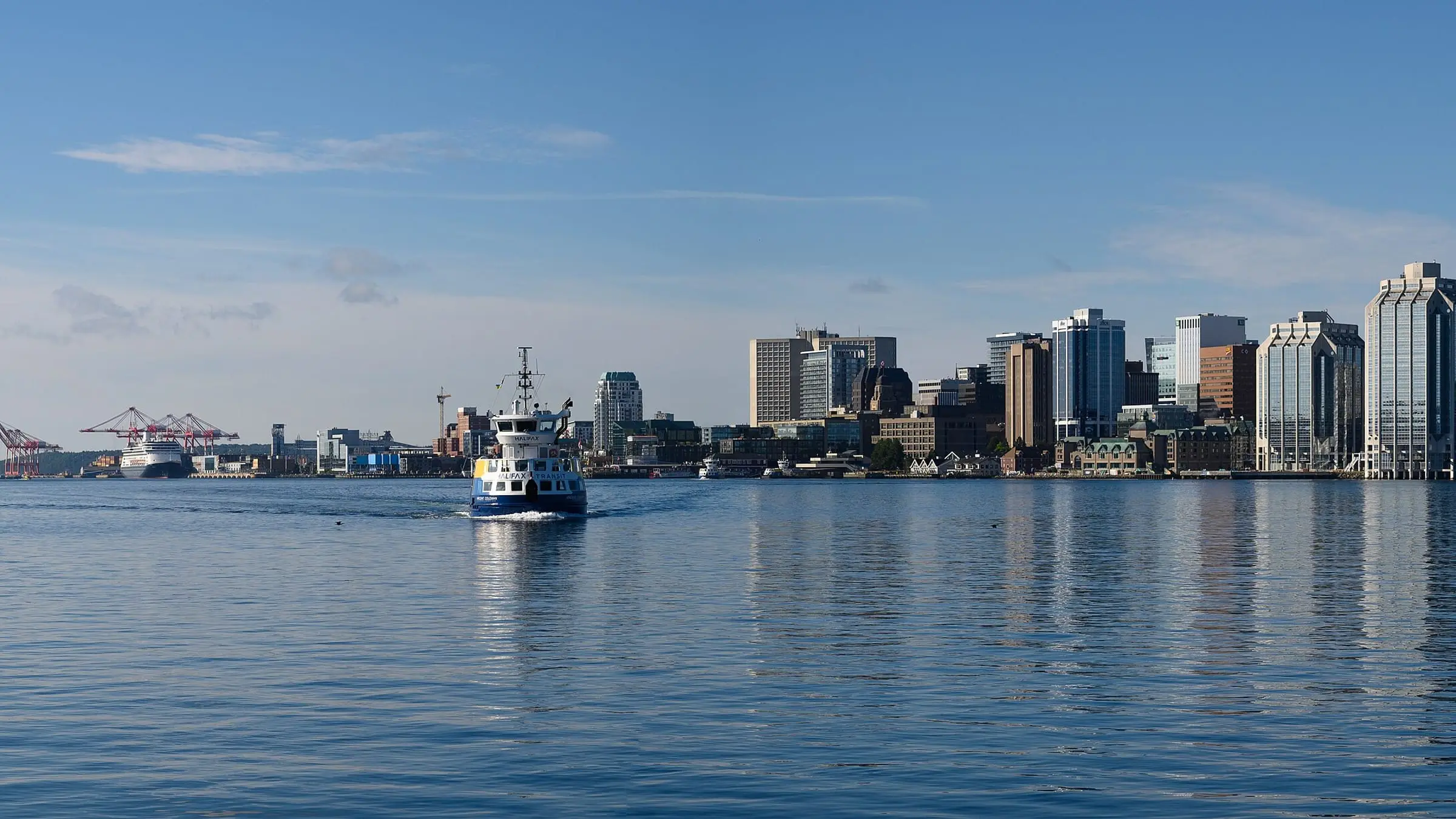 The Halifax skyline across the harbour, with a harbour ferry crossing